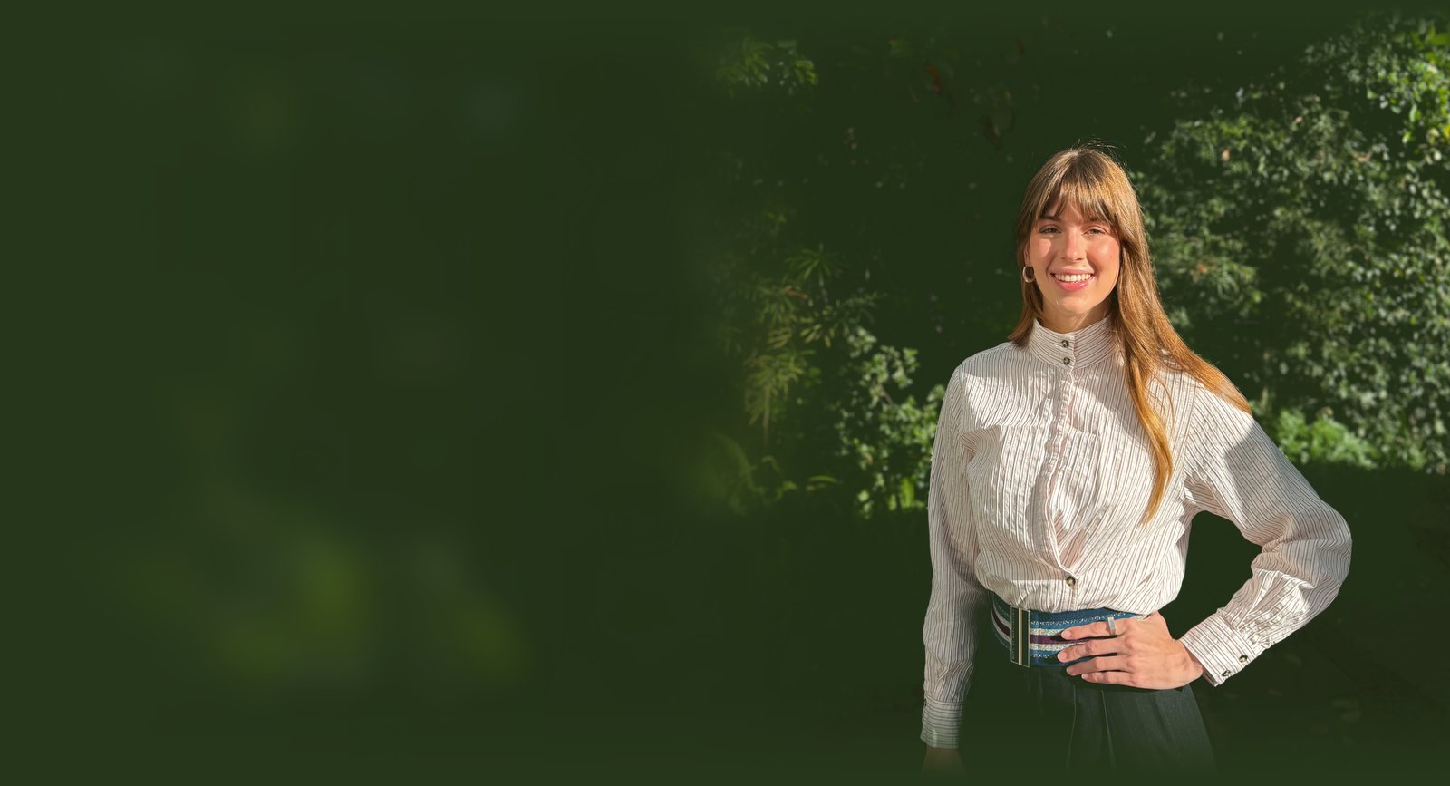 Tamryn Osler, smiling, standing outdoors in a garden.